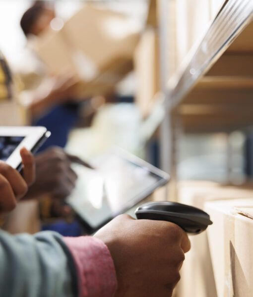 african-american-distribution-warehouse-worker-arm-scanning-box-code-scaled.jpg